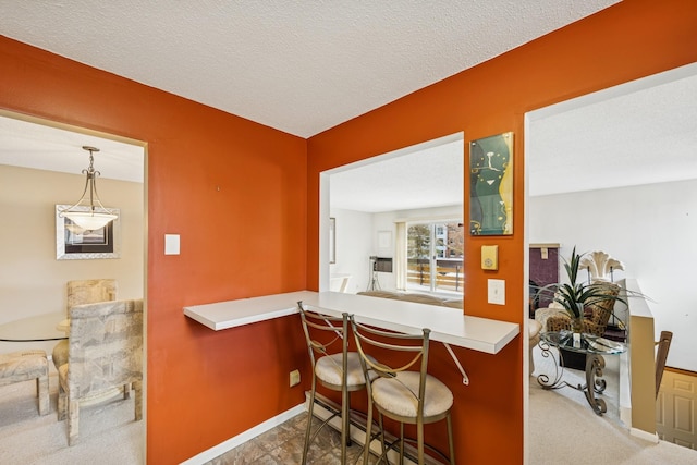 340 Ford Rd Unit 5, Saint Louis Park, MN 55426 - bar featuring baseboards, hanging light fixtures, and carpet floors