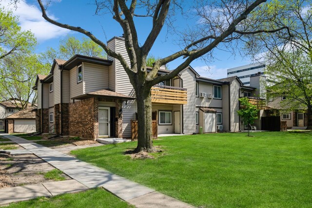 340 Ford Rd Unit 5, Saint Louis Park, MN 55426 - view of front of property featuring a front lawn, brick siding, a chimney, and a balcony