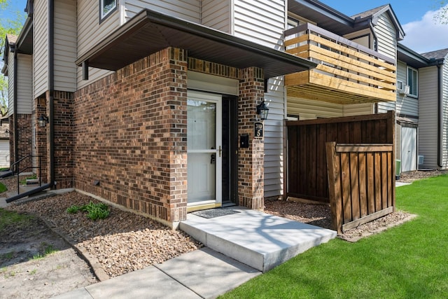 340 Ford Rd Unit 5, Saint Louis Park, MN 55426 - view of exterior entry with brick siding, a balcony, and an attached garage