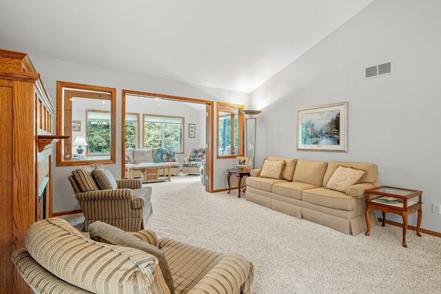 carpeted living room featuring lofted ceiling