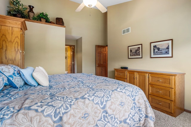 bedroom with a high ceiling and light carpet