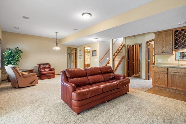 living room with light colored carpet and sink