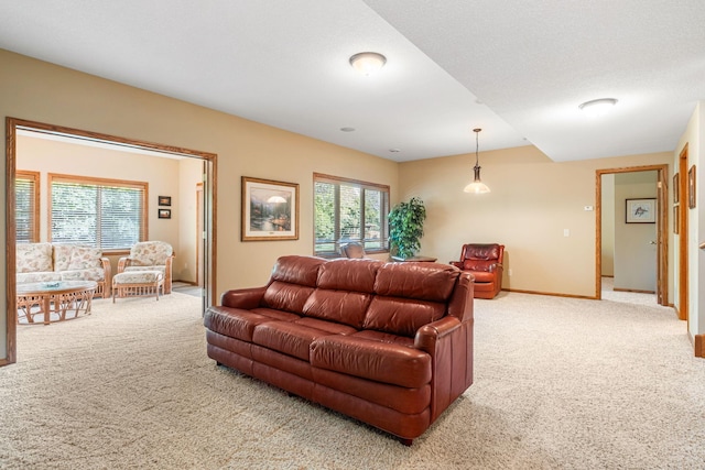 carpeted living room featuring a textured ceiling