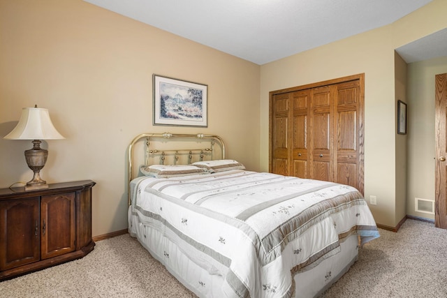 bedroom featuring light colored carpet and a closet