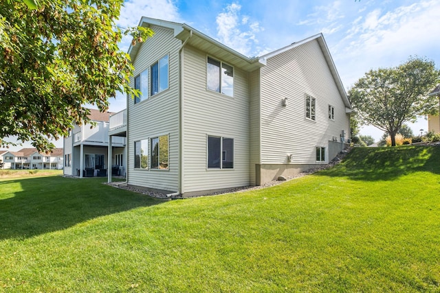 view of side of home with a yard