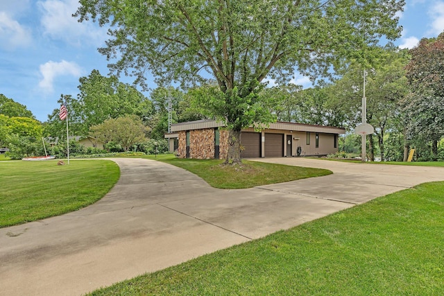 view of front of house featuring a garage and a front lawn