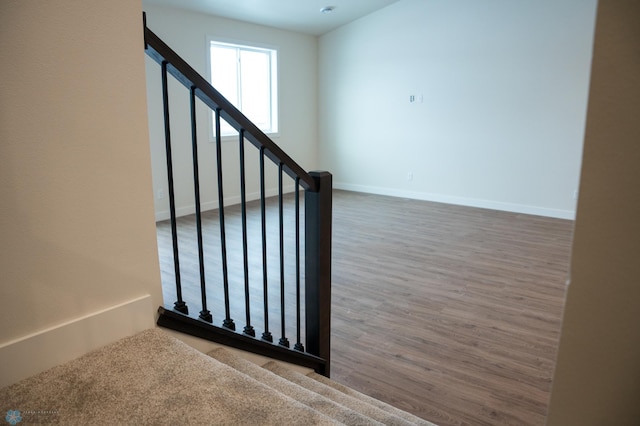 stairs featuring hardwood / wood-style flooring