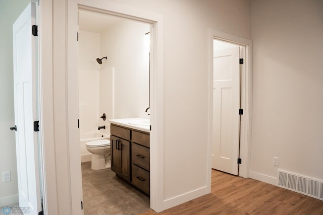 full bathroom with shower / tub combination, vanity, toilet, and hardwood / wood-style floors