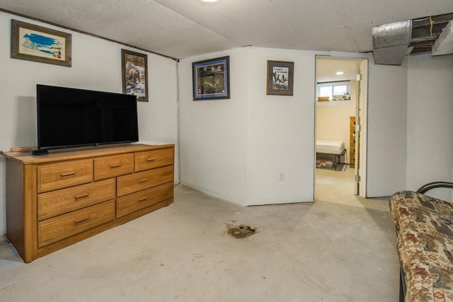 bedroom featuring concrete flooring