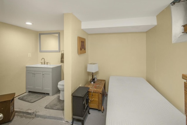 bathroom featuring toilet, recessed lighting, unfinished concrete floors, and vanity