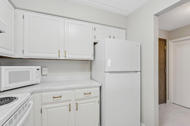 kitchen with white appliances, marble finish floor, light countertops, a textured ceiling, and white cabinetry