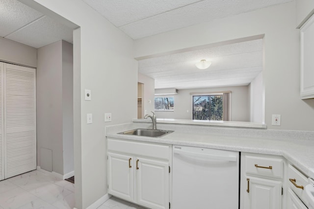 kitchen featuring a sink, white cabinets, light countertops, and dishwasher