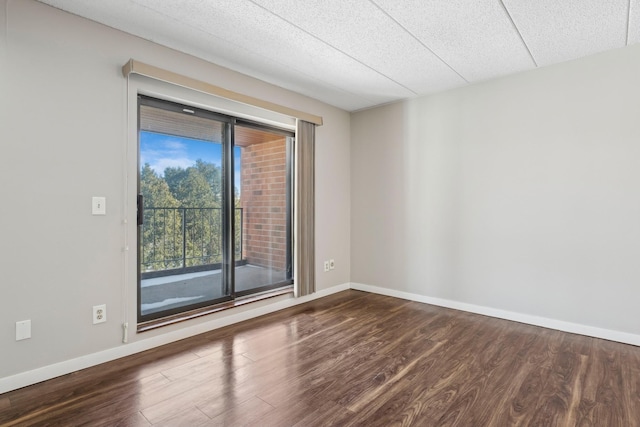 empty room featuring dark wood-style flooring and baseboards