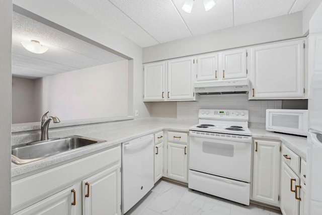 kitchen with under cabinet range hood, white cabinetry, white appliances, and light countertops