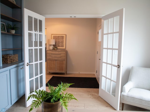 entryway with french doors and light hardwood / wood-style flooring