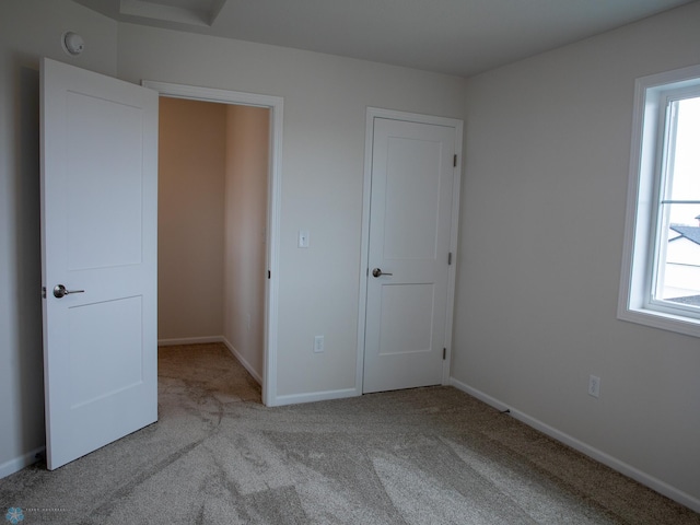 unfurnished bedroom with light colored carpet