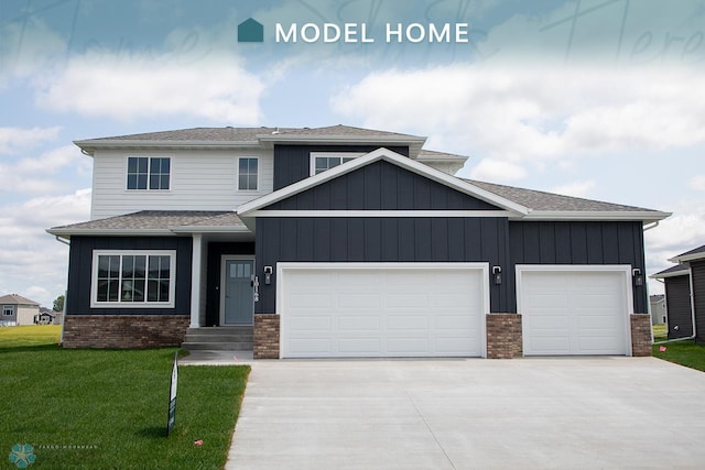 view of front of home with a garage and a front lawn