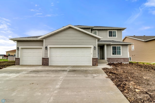 3515 18th St S, Moorhead, MN 56560 - traditional-style house with concrete driveway, brick siding, an attached garage, and roof with shingles