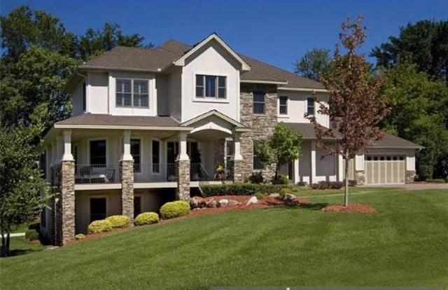 view of front of home featuring a garage and a front lawn