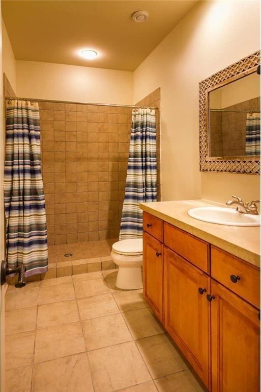 bathroom with tile patterned flooring, vanity, a shower with shower curtain, and toilet