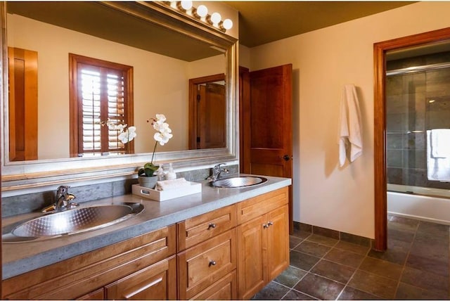 bathroom with vanity and bath / shower combo with glass door