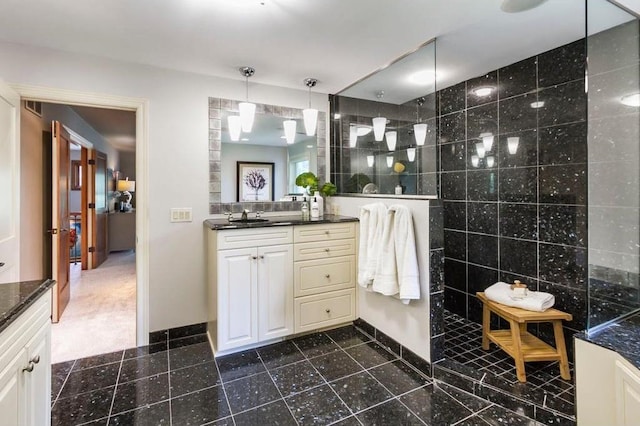 bathroom with vanity, tile walls, and walk in shower