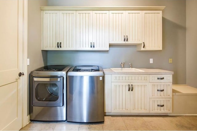 laundry area with sink, cabinets, and washing machine and clothes dryer