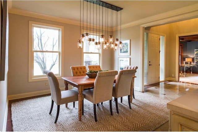 dining room featuring crown molding, tile patterned flooring, and a notable chandelier