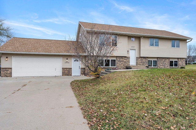 view of front of home with a garage and a front lawn