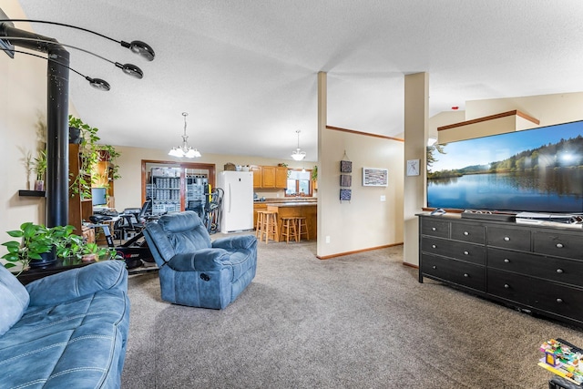 living room featuring lofted ceiling, a chandelier, carpet floors, and a textured ceiling