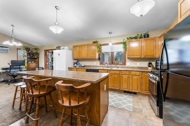 kitchen featuring a kitchen island, decorative light fixtures, a kitchen bar, and black appliances