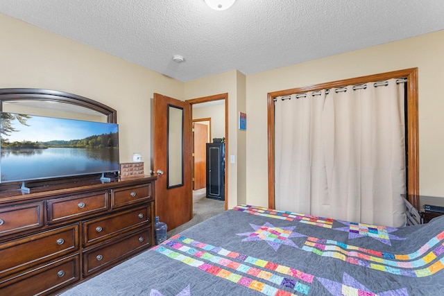 carpeted bedroom with a textured ceiling