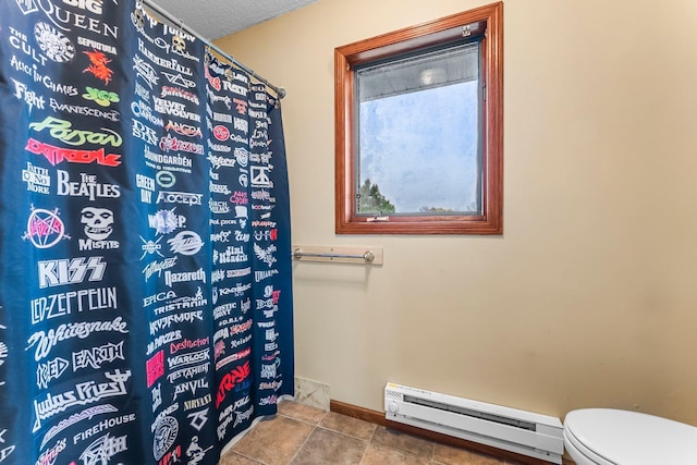 bathroom featuring baseboard heating and toilet