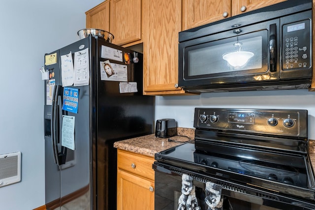 kitchen with stone countertops and black appliances