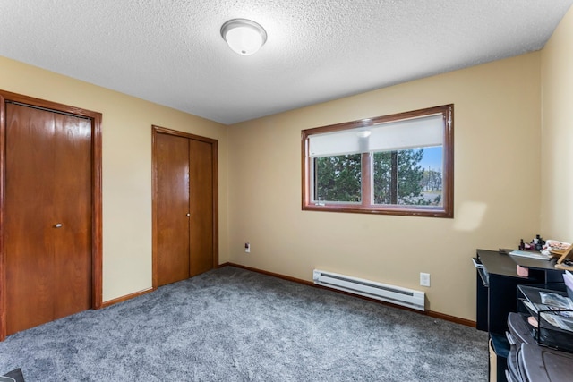 carpeted office featuring a baseboard radiator and a textured ceiling