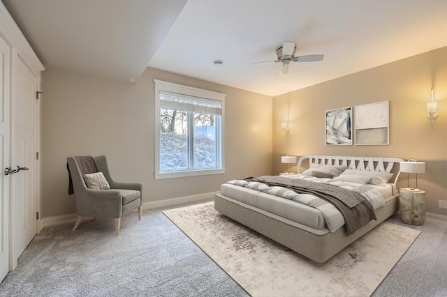 carpeted bedroom featuring ceiling fan and baseboards