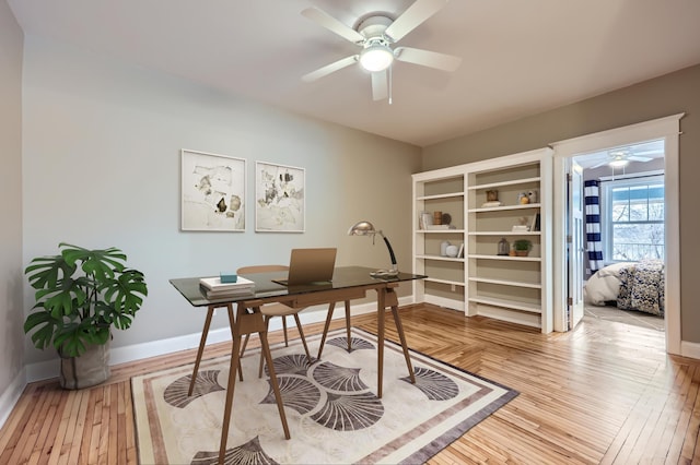 office area with ceiling fan and light hardwood / wood-style floors