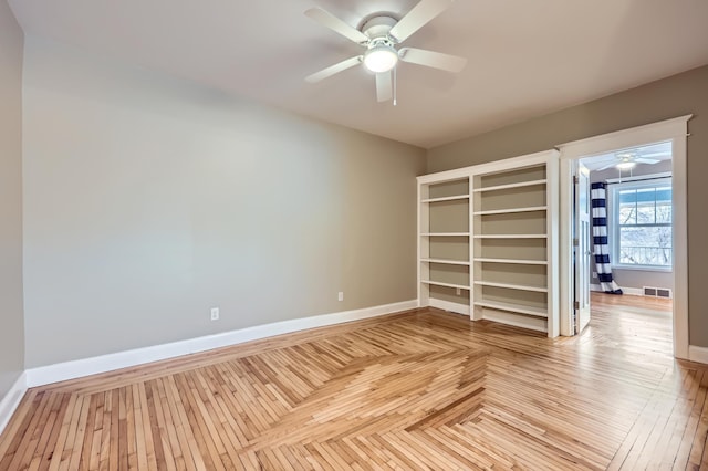 unfurnished bedroom with ceiling fan and light parquet floors