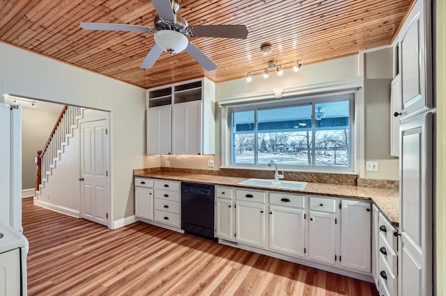 kitchen featuring black dishwasher, sink, white cabinets, and light hardwood / wood-style floors