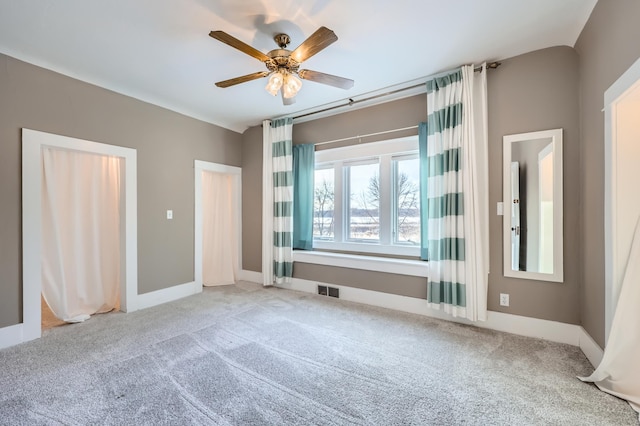 unfurnished bedroom featuring ceiling fan and carpet