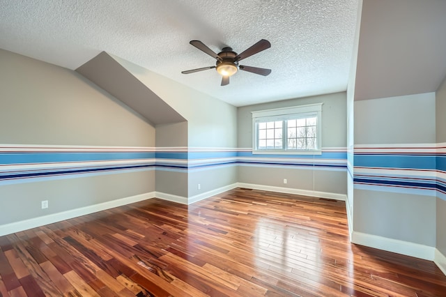 empty room featuring ceiling fan, hardwood / wood-style flooring, and a textured ceiling