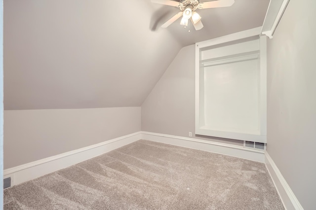 additional living space featuring vaulted ceiling, ceiling fan, and carpet flooring