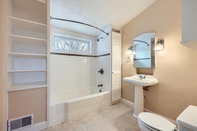 full bath with bathtub / shower combination, toilet, visible vents, baseboards, and tile patterned floors