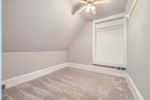 bonus room with carpet, lofted ceiling, visible vents, a ceiling fan, and baseboards