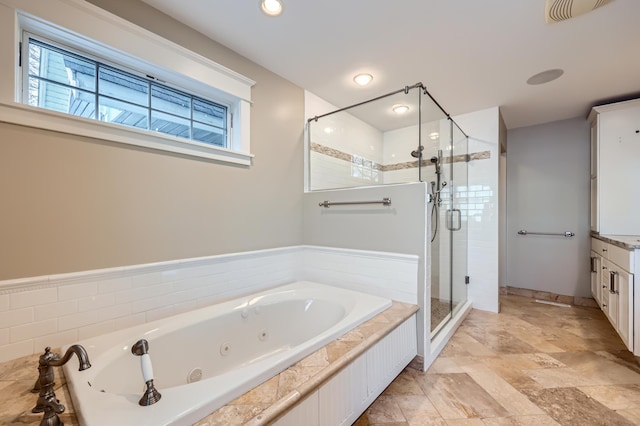 bathroom with a whirlpool tub, a stall shower, and visible vents