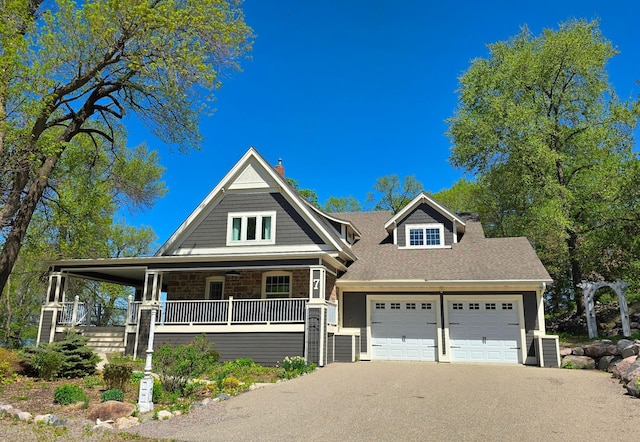 7 County Road 12 S, Buffalo, MN 55313 - view of front of property featuring covered porch, a garage, driveway, stone siding, and a shingled roof
