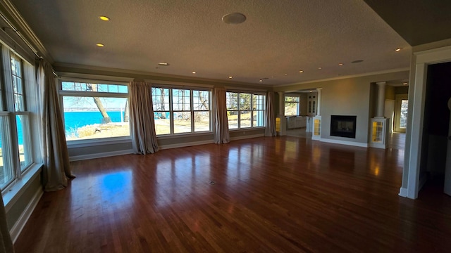 7 County Road 12 S, Buffalo, MN 55313 - unfurnished living room with a textured ceiling, baseboards, dark wood-type flooring, crown molding, and a fireplace