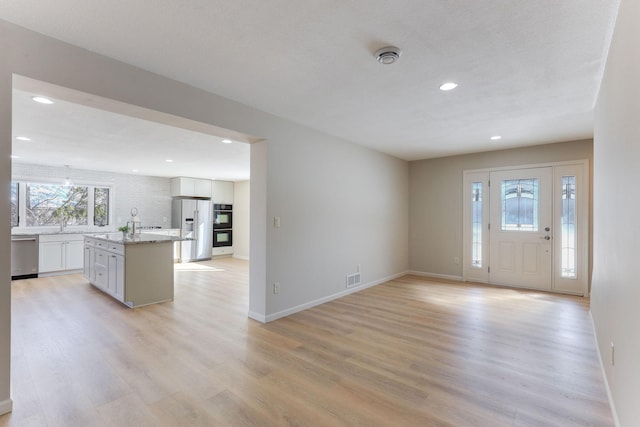 foyer entrance with light wood-type flooring