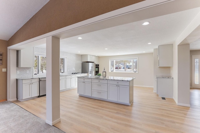3571 Centerville Rd, Vadnais Heights, MN 55127 - kitchen with dishwasher, a kitchen island, backsplash, plenty of natural light, and recessed lighting