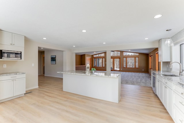 3571 Centerville Rd, Vadnais Heights, MN 55127 - kitchen featuring a sink, stainless steel appliances, baseboards, light wood-style flooring, and recessed lighting